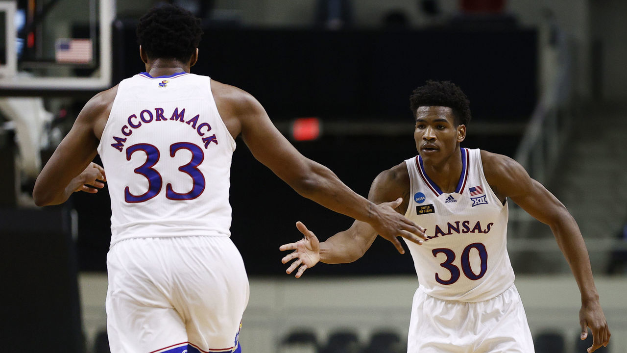 INDIANAPOLIS, INDIANA - MARCH 20: Ochai Agbaji #30 of the Kansas Jayhawks and David McCormack #33 of the Kansas Jayhawks react to a basket during the second half against the Eastern Washington Eagles in the first round game of the 2021 NCAA Men's Basketball Tournament at Indiana Farmers Coliseum on March 20, 2021 in Indianapolis, Indiana.