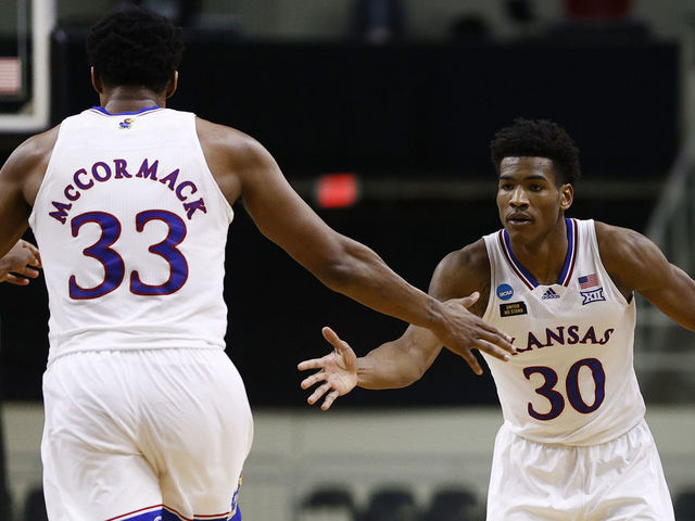 INDIANAPOLIS, INDIANA - MARCH 20: Ochai Agbaji #30 of the Kansas Jayhawks and David McCormack #33 of the Kansas Jayhawks react to a basket during the second half against the Eastern Washington Eagles in the first round game of the 2021 NCAA Men's Basketball Tournament at Indiana Farmers Coliseum on March 20, 2021 in Indianapolis, Indiana.