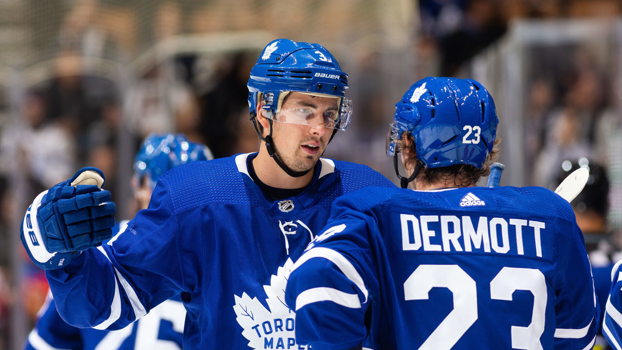 TORONTO, ON - OCTOBER 29: Toronto Maple Leafs defenseman Justin Holl #3 talks with teammate Travis Dermott at an NHL game against the Washington Capitals during the first period at the Scotiabank Arena on October 29, 2019 in Toronto, Ontario, Canada.