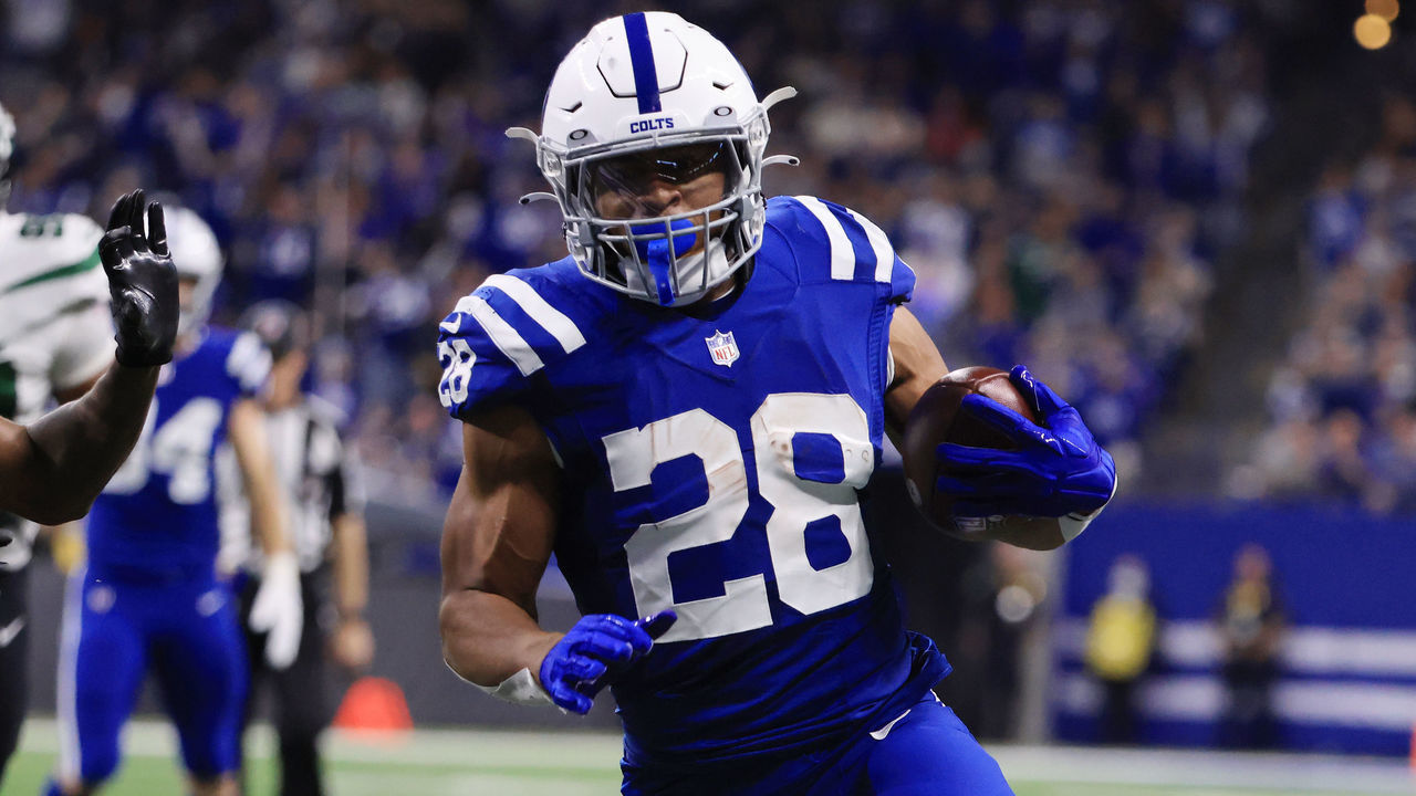 INDIANAPOLIS, INDIANA - NOVEMBER 04: Jonathan Taylor #28 of the Indianapolis Colts runs for a touchdown as Brandin Echols #26 of the New York Jets defends during the first half at Lucas Oil Stadium on November 04, 2021 in Indianapolis, Indiana.