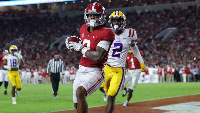 TUSCALOOSA, ALABAMA - NOVEMBER 06: John Metchie III #8 of the Alabama Crimson Tide pulls in this touchdown reception against Dwight McGlothern #2 of the LSU Tigers during the first half at Bryant-Denny Stadium on November 06, 2021 in Tuscaloosa, Alabama.