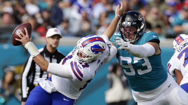 JACKSONVILLE, FL - NOVEMBER 07: Jacksonville Jaguars defensive tackle Taven Bryan (93) sacks .Buffalo Bills quarterback Josh Allen (17) during the game between the Buffalo Bills and the Jacksonville Jaguars on November 7, 2021 at TIAA Bank Field in Jacksonville, FL.