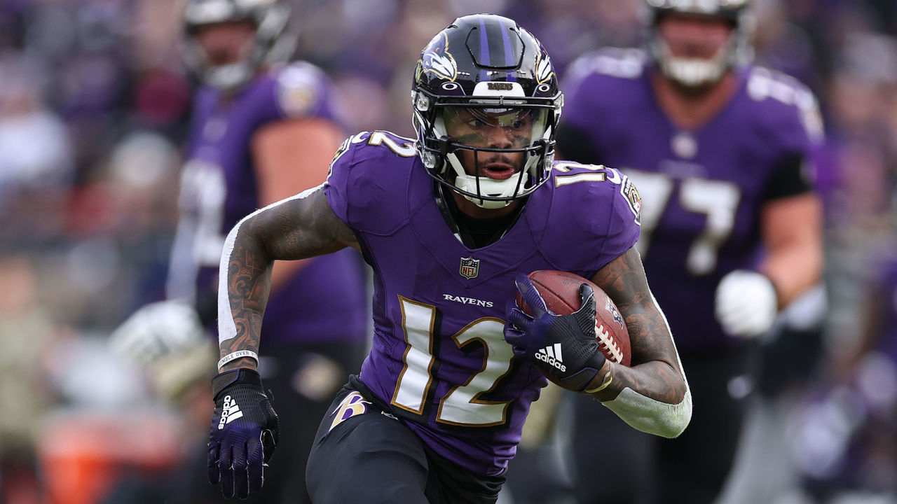 BALTIMORE, MARYLAND - NOVEMBER 07: Rashod Bateman #12 of the Baltimore Ravens runs with the ball against the Minnesota Vikings in the fourth quarter at M&T Bank Stadium on November 07, 2021 in Baltimore, Maryland.
