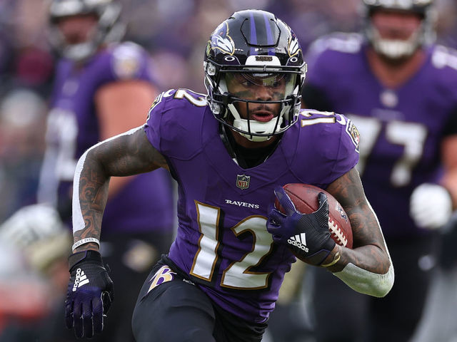 BALTIMORE, MARYLAND - NOVEMBER 07: Rashod Bateman #12 of the Baltimore Ravens runs with the ball against the Minnesota Vikings in the fourth quarter at M&T Bank Stadium on November 07, 2021 in Baltimore, Maryland.