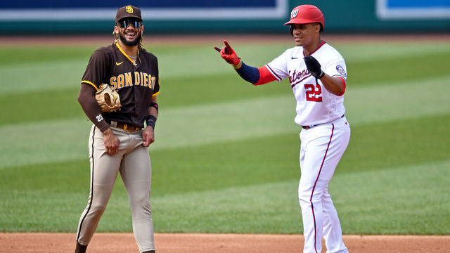 WASHINGTON, DC - JULY 18, 2021: Juan Soto #22 of the Washington Nationals jokes with Fernando Tatis Jr. #23 of the San Diego Padres in the third inning at Nationals Park on July 18, 2021 in Washington, DC.