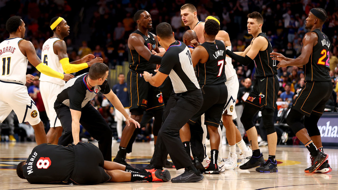 DENVER, CO - NOVEMBER 08: Markieff Morris #8 of the Miami Heat lays on the ground after being hit by Nikola Jokic #15 of the Denver Nuggets at Ball Arena on November 8, 2021 in Denver, Colorado.