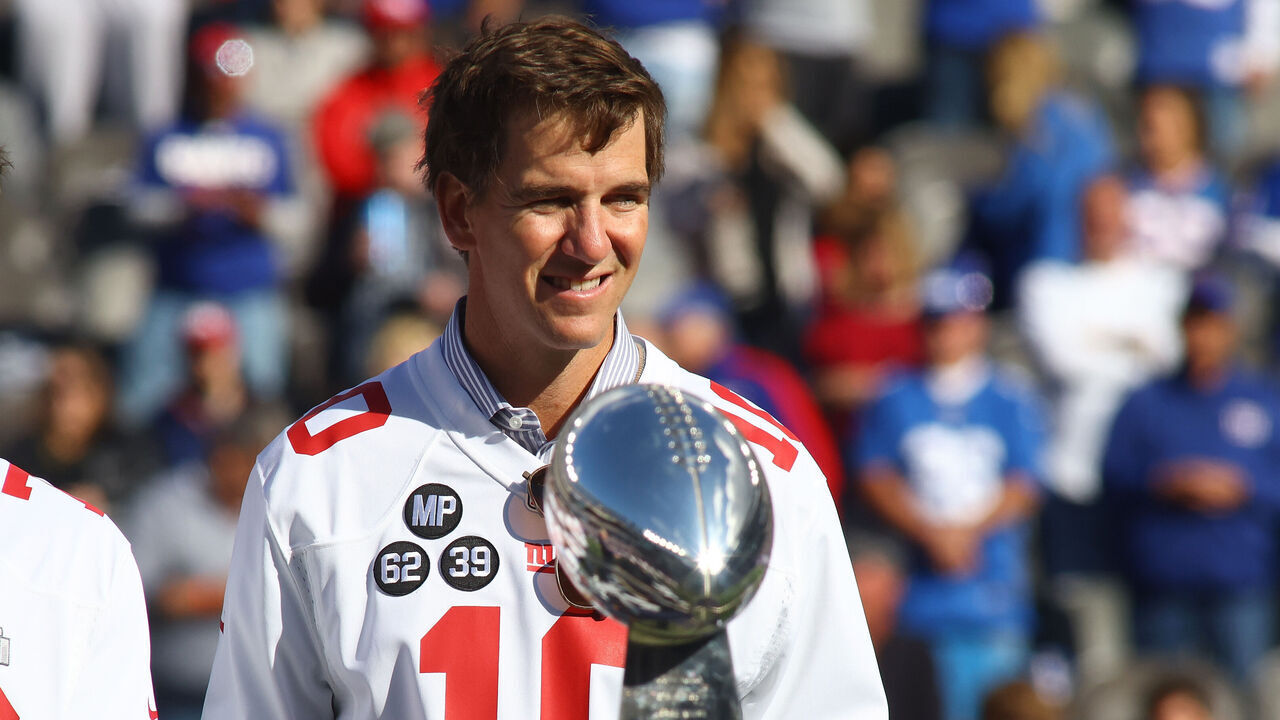 EAST RUTHERFORD, NEW JERSEY - OCTOBER 17: Former New York Giants Eli Manning looks on during a ceremony to honor the 2011 Super Bowl championship team at MetLife Stadium on October 17, 2021 in East Rutherford, New Jersey. Los Angeles Rams defeated the New York Giants 38-11.