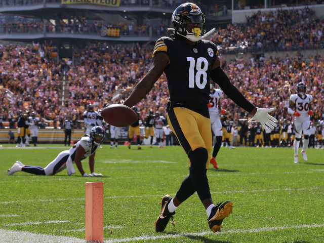 PITTSBURGH, PENNSYLVANIA - OCTOBER 10: Diontae Johnson #18 of the Pittsburgh Steelers crosses the goal line to score a 50-yard touchdown reception against the Denver Broncos during the first quarter at Heinz Field on October 10, 2021 in Pittsburgh, Pennsylvania.