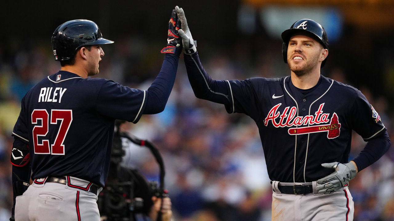 LOS ANGELES, CA - OCTOBER 20: Freddie Freeman #5 of the Atlanta Braves is congratulated by Austin Riley #27 after hitting a solo home run in the third inning during Game 4 of the NLCS between the Atlanta Braves and the Los Angeles Dodgers at Dodgers Stadium on Wednesday, October 20, 2021 in Los Angeles, California.