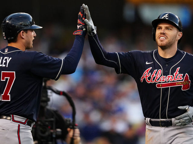 LOS ANGELES, CA - OCTOBER 20: Freddie Freeman #5 of the Atlanta Braves is congratulated by Austin Riley #27 after hitting a solo home run in the third inning during Game 4 of the NLCS between the Atlanta Braves and the Los Angeles Dodgers at Dodgers Stadium on Wednesday, October 20, 2021 in Los Angeles, California.