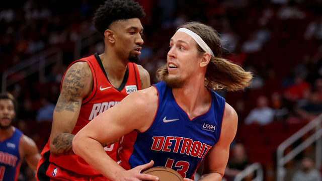 HOUSTON, TEXAS - NOVEMBER 10: Kelly Olynyk #13 of the Detroit Pistons controls the ball ahead of Christian Wood #35 of the Houston Rockets during the second half at Toyota Center on November 10, 2021 in Houston, Texas.