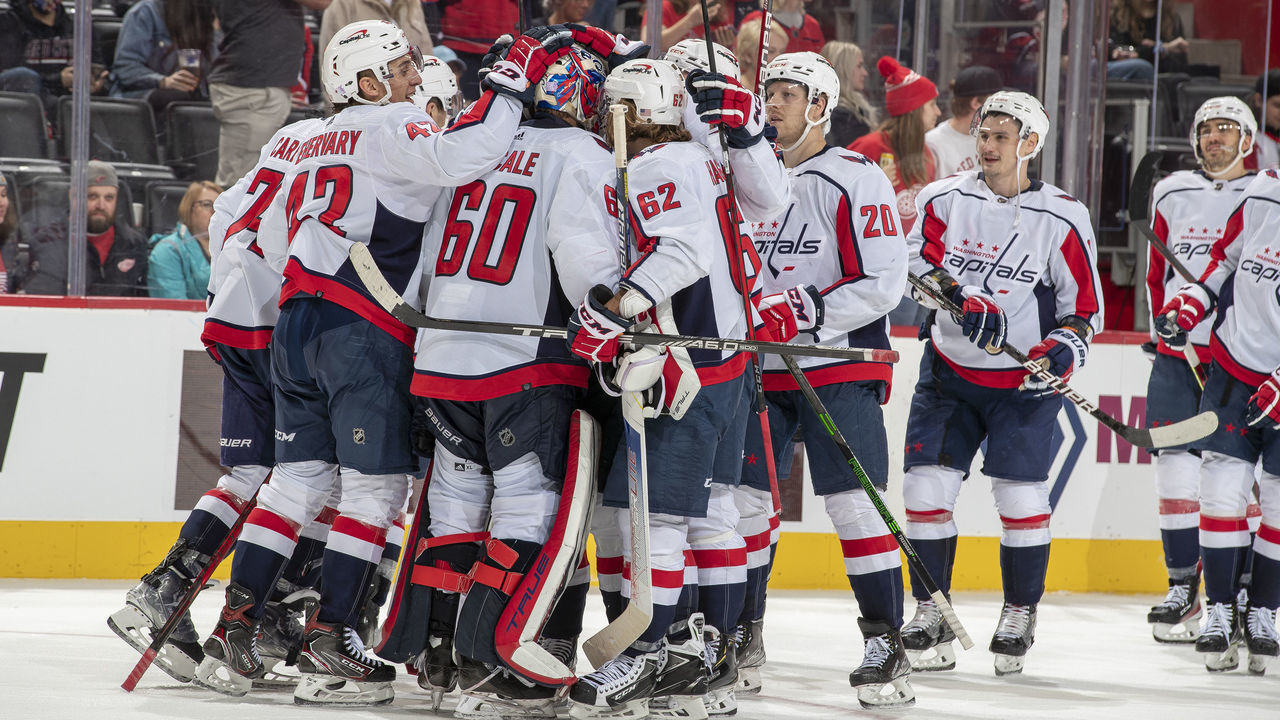 DETROIT, MI - NOVEMBER 11: Zach Fucale #60 of the Washington Capitals is congratulated by teammates for his first shut out, in his first NHL game against the Detroit Red Wings at Little Caesars Arena on November 11, 2021 in Detroit, Michigan. Washington defeated Detroit 2-0.