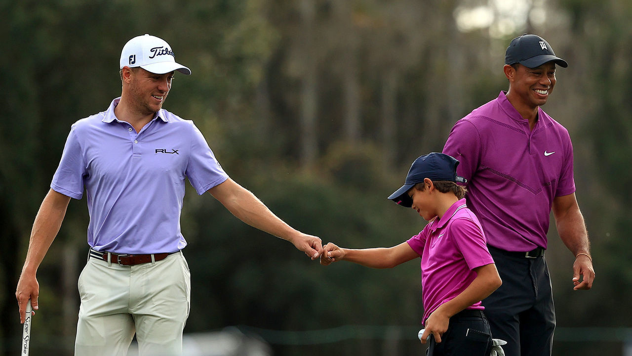 ORLANDO, FLORIDA - DECEMBER 19: Tiger Woods of the United States' son Charlie Woods high five Justin Thomas of the United States on the ninth hole during the first round of the PNC Championship at the Ritz Carlton Golf Club on December 19, 2020 in Orlando, Florida.