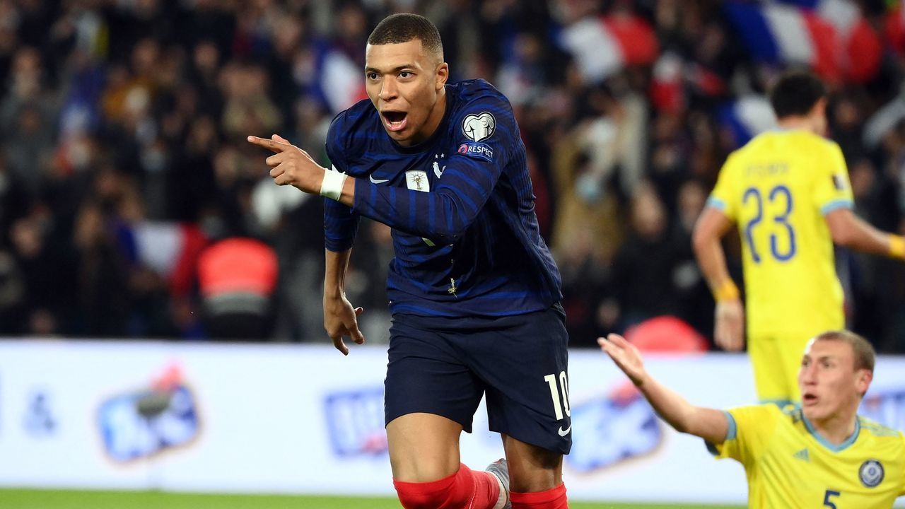 France's forward Kylian Mbappe (L) celebrates after scoring a goal during the FIFA World Cup 2022 qualification football match between France and Kazhakstan at the Parc des Princes stadium in Paris, on November 13, 2021.