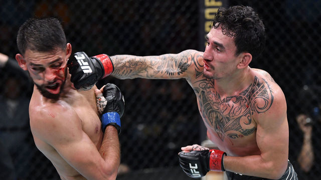 LAS VEGAS, NEVADA - NOVEMBER 13: (R-L) Max Holloway punches Yair Rodriguez of Mexico in a featherweight fight during the UFC Fight Night event at UFC APEX on November 13, 2021 in Las Vegas, Nevada.