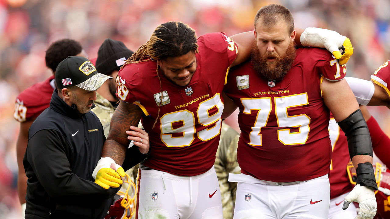 LANDOVER, MARYLAND - NOVEMBER 14: Chase Young #99 of the Washington Football Team is help off the field after an injury during the first half against the Tampa Bay Buccaneers at FedExField on November 14, 2021 in Landover, Maryland.