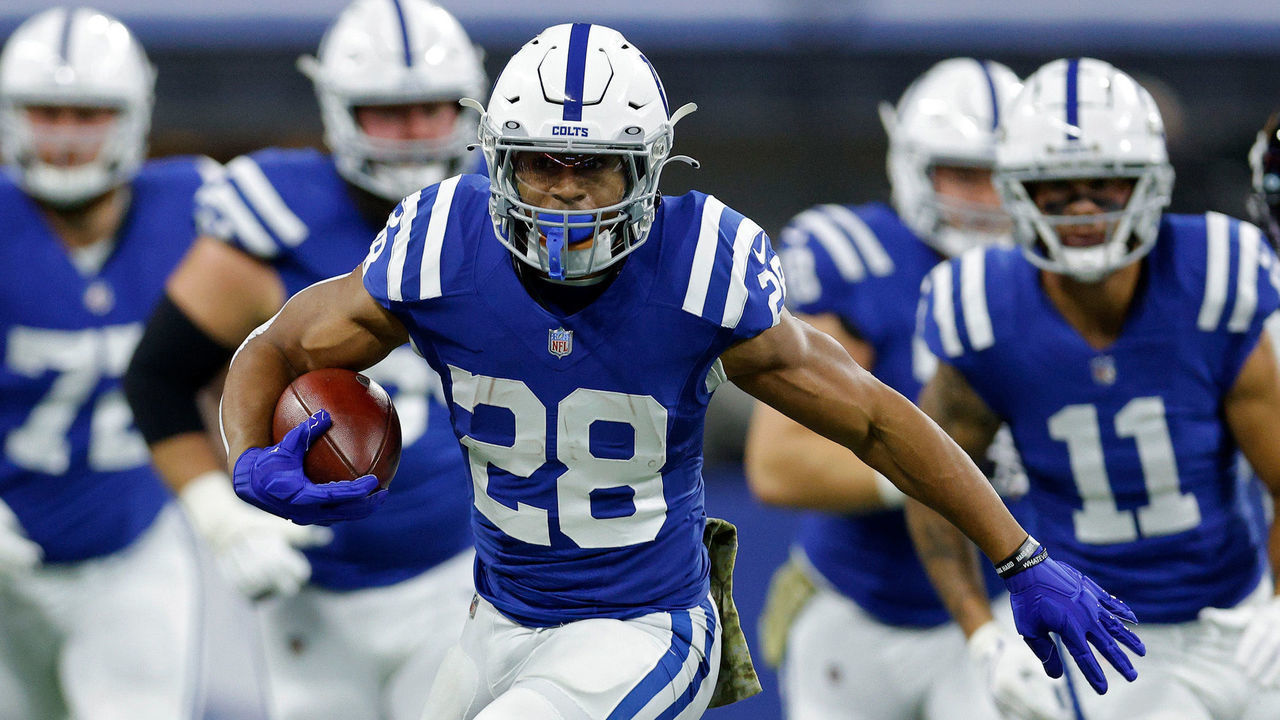 INDIANAPOLIS, INDIANA - NOVEMBER 14: Jonathan Taylor #28 of the Indianapolis Colts runs with the ball as Andrew Wingard #42 of the Jacksonville Jaguars defends during the first half at Lucas Oil Stadium on November 14, 2021 in Indianapolis, Indiana.
