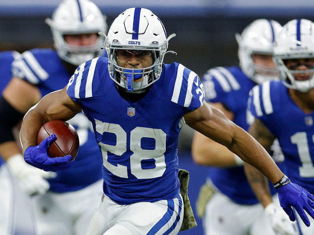 INDIANAPOLIS, INDIANA - NOVEMBER 14: Jonathan Taylor #28 of the Indianapolis Colts runs with the ball as Andrew Wingard #42 of the Jacksonville Jaguars defends during the first half at Lucas Oil Stadium on November 14, 2021 in Indianapolis, Indiana.