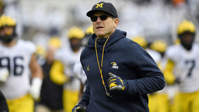 UNIVERSITY PARK, PA - NOVEMBER 13: Michigan head coach Jim Harbaugh leads the team off the field during the Michigan Wolverines versus Penn State Nittany Lions game on November 13, 2021 at Beaver Stadium in University Park, PA.