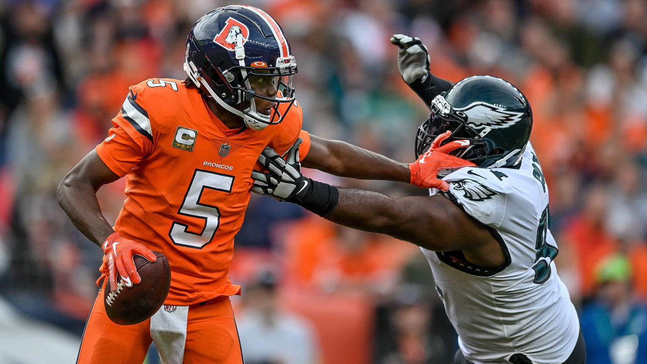 DENVER, CO - NOVEMBER 14: Denver Broncos quarterback Teddy Bridgewater (5) is pressured by Philadelphia Eagles defensive tackle Fletcher Cox (91) during a game between the Denver Broncos and the Philadelphia Eagles at Empower Field at Mile High on November 14, 2021 in Denver, Colorado.