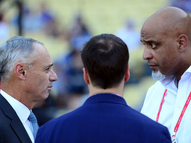 LOS ANGELES, CA - OCTOBER 25: Major League Baseball Commissioner Robert D. Manfred Jr. talks with Executive Director of the Major League Baseball Players Association Tony Clark during batting practice prior to Game 2 of the 2017 World Series between the Houston Astros and the Los Angeles Dodgers at Dodger Stadium on Wednesday, October 25, 2017 in Los Angeles, California.