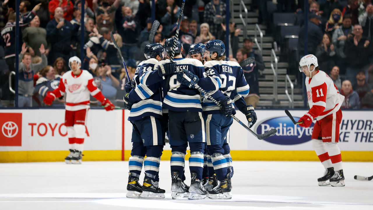 COLUMBUS, OH - NOVEMBER 15: Zach Werenski #8 of the Columbus Blue Jackets is congratulated by his teammates after scoring a goal during the third period against the Detroit Red Wings at Nationwide Arena on November 15, 2021 in Columbus, Ohio. Columbus defeated Detroit 5-3.