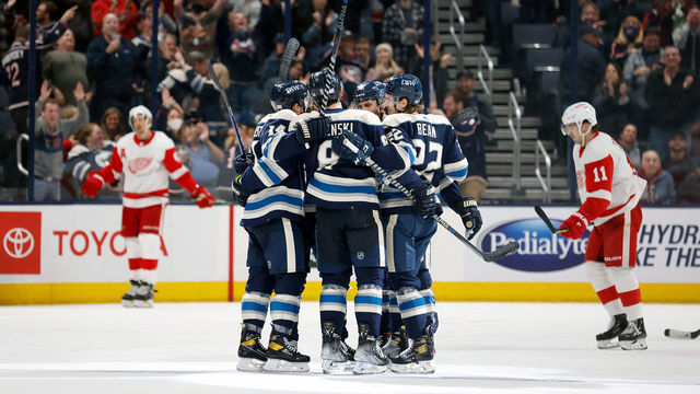 COLUMBUS, OH - NOVEMBER 15: Zach Werenski #8 of the Columbus Blue Jackets is congratulated by his teammates after scoring a goal during the third period against the Detroit Red Wings at Nationwide Arena on November 15, 2021 in Columbus, Ohio. Columbus defeated Detroit 5-3.
