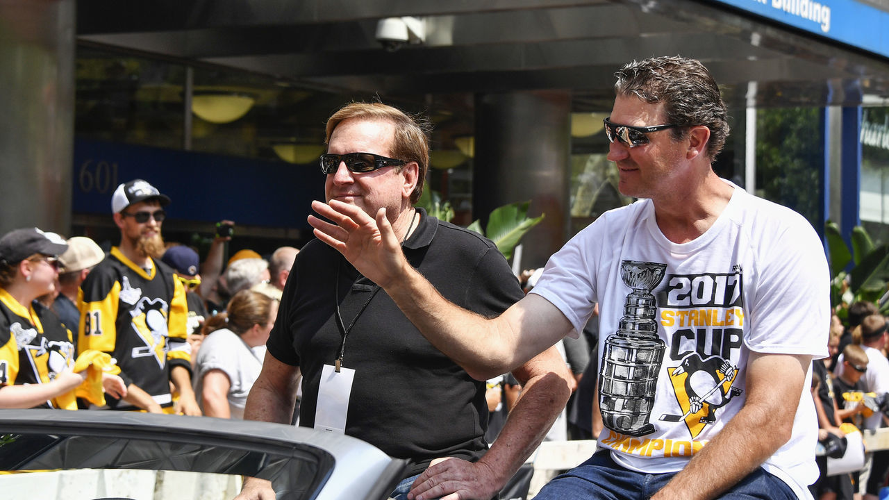 PITTSBURGH, PA - JUNE 14: Pittsburgh Penguins owners Ron Burkle (left) and Mario Lemieux (right) wave to fans during the 2017 Pittsburgh Penguins Stanley Cup Champion Victory Parade on June 14, 2017 in Pittsburgh, PA.