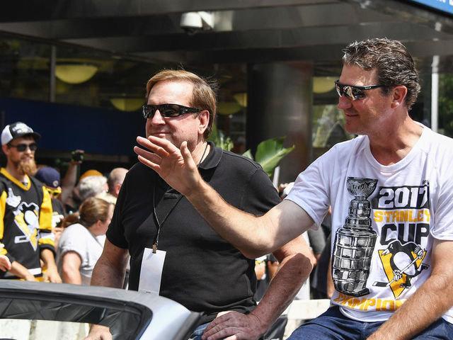 PITTSBURGH, PA - JUNE 14: Pittsburgh Penguins owners Ron Burkle (left) and Mario Lemieux (right) wave to fans during the 2017 Pittsburgh Penguins Stanley Cup Champion Victory Parade on June 14, 2017 in Pittsburgh, PA.