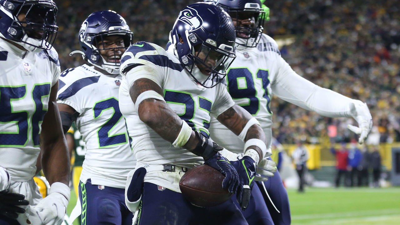 GREEN BAY, WI - NOVEMBER 14: Seattle Seahawks safety Jamal Adams (33) does Green Bay Packers quarterback Aaron Rodgers (12) signature championship belt move during a game between the Green Bay Packers and the Seattle Seahawks at Lambeau Field on November 14, 2021 in Green Bay, WI.