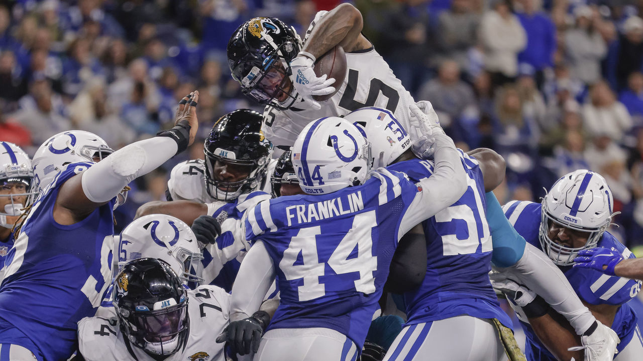 INDIANAPOLIS, IN - NOVEMBER 14: James Robinson #25 of the Jacksonville Jaguars goes up high to score during the game against the Indianapolis Colts at Lucas Oil Stadium on November 14, 2021 in Indianapolis, Indiana.