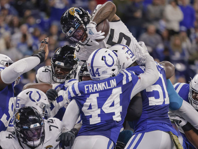 INDIANAPOLIS, IN - NOVEMBER 14: James Robinson #25 of the Jacksonville Jaguars goes up high to score during the game against the Indianapolis Colts at Lucas Oil Stadium on November 14, 2021 in Indianapolis, Indiana.