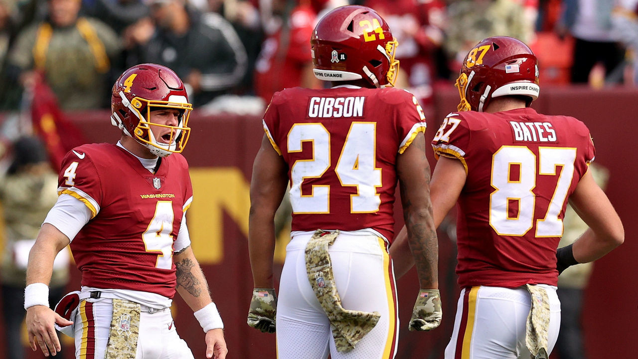 LANDOVER, MARYLAND - NOVEMBER 14: Taylor Heinicke #4 of the Washington Football Team, John Bates #87 and Antonio Gibson #24 celebrate a touchdown during the first half against the Tampa Bay Buccaneers at FedExField on November 14, 2021 in Landover, Maryland.