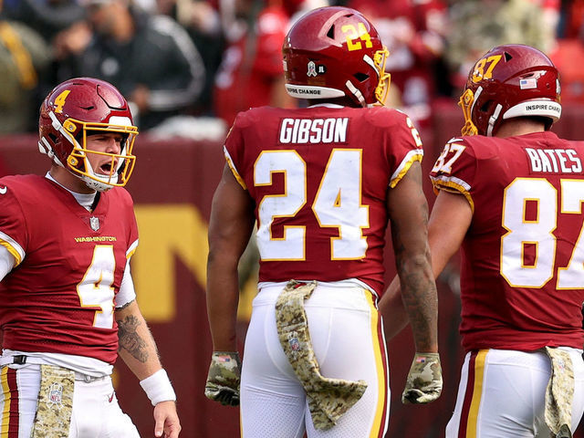 LANDOVER, MARYLAND - NOVEMBER 14: Taylor Heinicke #4 of the Washington Football Team, John Bates #87 and Antonio Gibson #24 celebrate a touchdown during the first half against the Tampa Bay Buccaneers at FedExField on November 14, 2021 in Landover, Maryland.