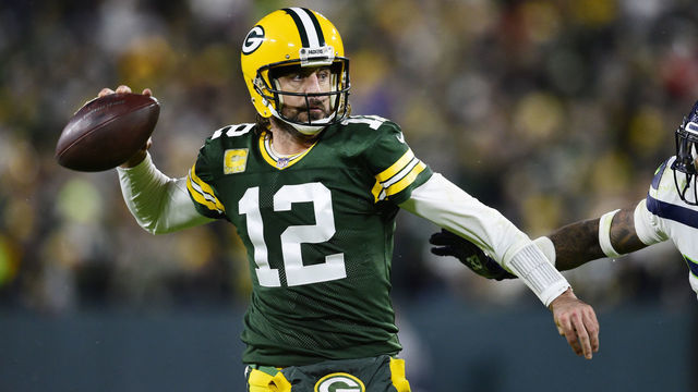 GREEN BAY, WISCONSIN - NOVEMBER 14: Aaron Rodgers #12 of the Green Bay Packers looks to pass the ball in the second half against the Seattle Seahawks at Lambeau Field on November 14, 2021 in Green Bay, Wisconsin.