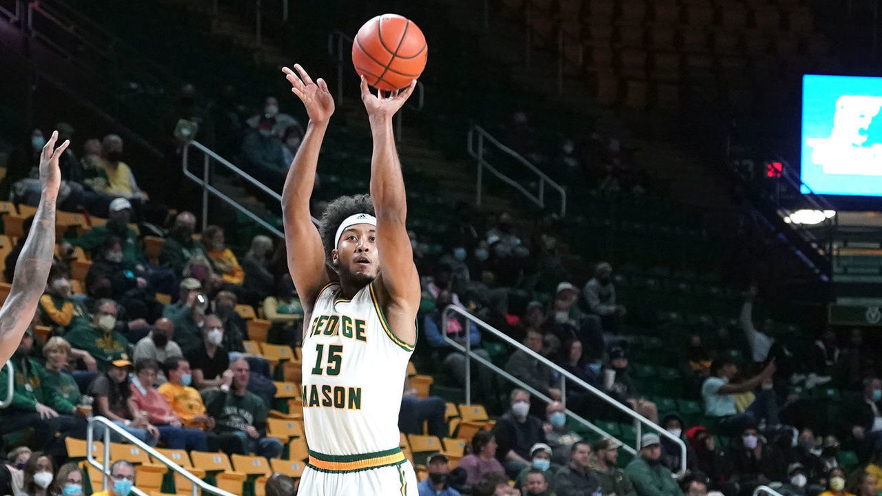 FAIRFAX, VIRGINIA - NOVEMBER 14: D'Shawn Schwartz #15 of the George Mason Patriots takes a shot over Keith McGee #3 of the Morgan State Bears in the first half during a college basketball game at the Eagle Bank Arena on November 14, 2021 in Fairfax, Virginia.