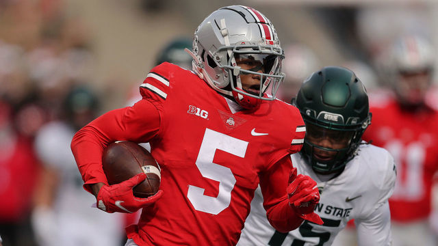 COLUMBUS, OHIO - NOVEMBER 20: Garrett Wilson #5 of the Ohio State Buckeyes catches a first quarter touchdown pass in front of Angelo Grose #15 of the Michigan State Spartans at Ohio Stadium on November 20, 2021 in Columbus, Ohio.