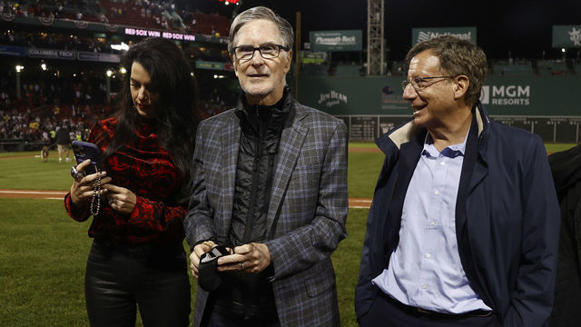BOSTON, MA - OCTOBER 5: Boston Red Sox Principal Owner John Henry, his wife Linda Pizzuti Henry and Chairman Tom Werner after the AL Wild Card playoff game against the New York Yankees at Fenway Park on October 6, 2021 in Boston, Massachusetts.