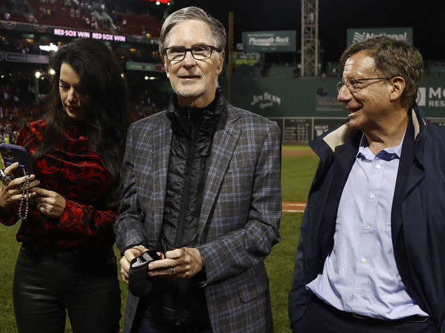 BOSTON, MA - OCTOBER 5: Boston Red Sox Principal Owner John Henry, his wife Linda Pizzuti Henry and Chairman Tom Werner after the AL Wild Card playoff game against the New York Yankees at Fenway Park on October 6, 2021 in Boston, Massachusetts.