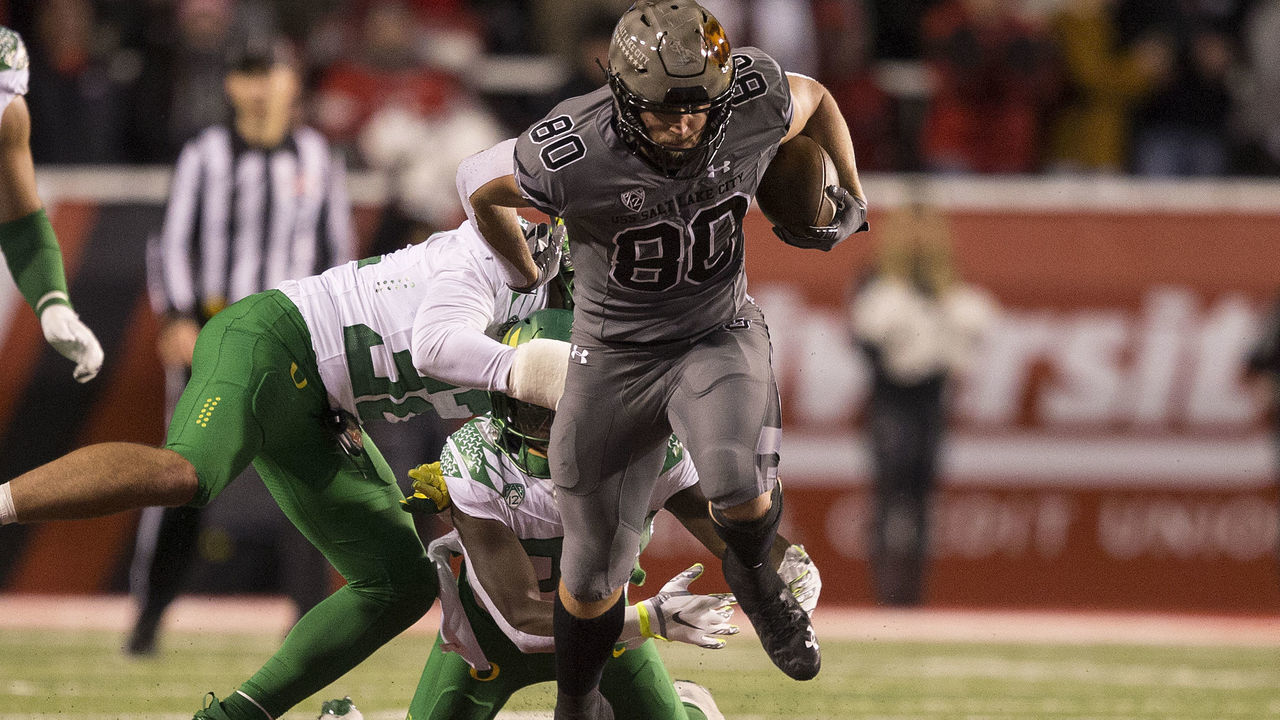 SALT LAKE CITY, UT - NOVEMBER 20: Brant Kuithe #80 of the Utah Utes breaks a tackle attempt by Jordan Happle #32 of the Oregon Ducks during their game November 20, 2021 at Rice-Eccles Stadium in Salt Lake City , Utah.