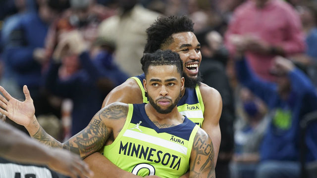 MINNEAPOLIS, MN - NOVEMBER 20: Karl-Anthony Towns #32 of the Minnesota Timberwolves hugs D'Angelo Russell #0 of the Minnesota Timberwolves during the game against the Memphis Grizzlies on November 20, 2021 at Target Center in Minneapolis, Minnesota. Mandatory Copyright Notice: Copyright 2021 NBAE