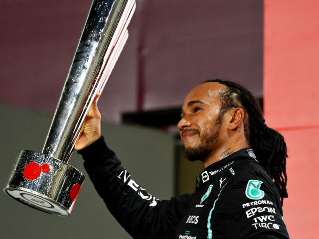 DOHA, QATAR - NOVEMBER 21: Race winner Lewis Hamilton of Great Britain and Mercedes GP celebrates on the podium during the F1 Grand Prix of Qatar at Losail International Circuit on November 21, 2021 in Doha, Qatar.