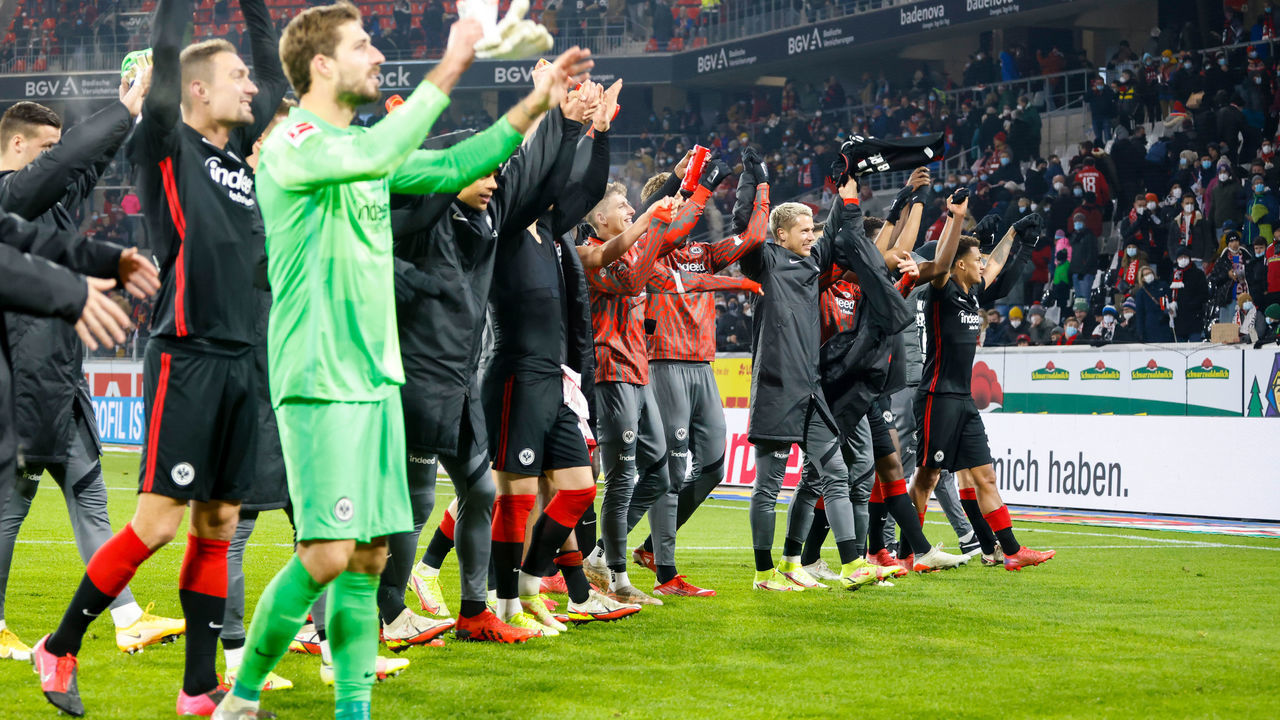 21 November 2021, Baden-Wuerttemberg, Freiburg Im Breisgau: Football: Bundesliga, SC Freiburg - Eintracht Frankfurt, Matchday 12, at Europa-Park Stadium. Frankfurt's players cheer in front of the fans after the match. IMPORTANT NOTE: In accordance with the regulations of the DFL German Football League and the DFB German Football Association, it is prohibited to use or have used photographs taken in the stadium and/or of the match in the form of sequence pictures and/or video-like photo series. Photo: Philipp Von Ditfurth/dpa