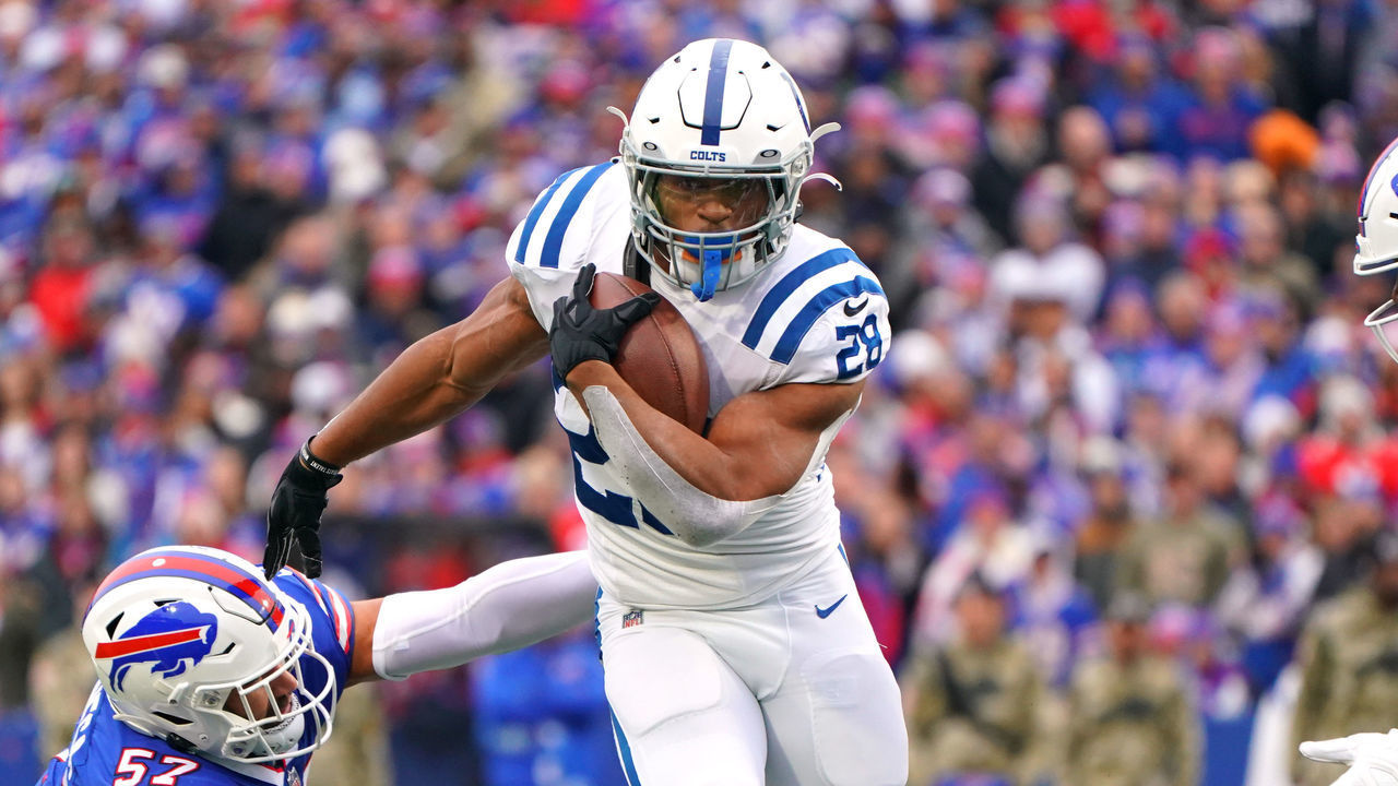 ORCHARD PARK, NEW YORK - NOVEMBER 21: Jonathan Taylor #28 of the Indianapolis Colts avoids a tackle by A.J. Epenesa #57 of the Buffalo Bills during the first quarter at Highmark Stadium on November 21, 2021 in Orchard Park, New York.
