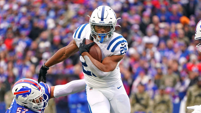 ORCHARD PARK, NEW YORK - NOVEMBER 21: Jonathan Taylor #28 of the Indianapolis Colts avoids a tackle by A.J. Epenesa #57 of the Buffalo Bills during the first quarter at Highmark Stadium on November 21, 2021 in Orchard Park, New York.