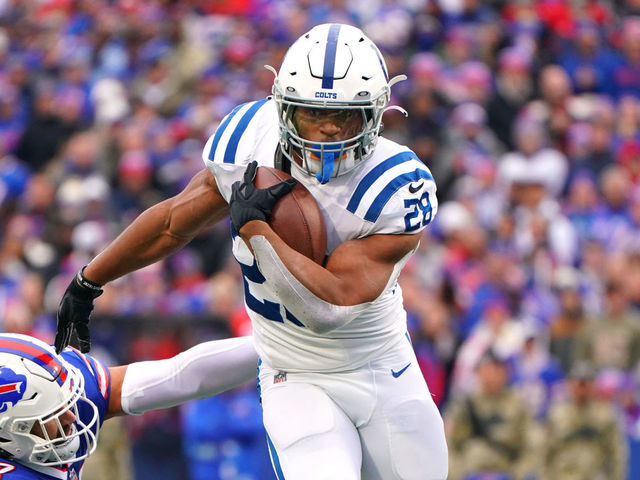 ORCHARD PARK, NEW YORK - NOVEMBER 21: Jonathan Taylor #28 of the Indianapolis Colts avoids a tackle by A.J. Epenesa #57 of the Buffalo Bills during the first quarter at Highmark Stadium on November 21, 2021 in Orchard Park, New York.
