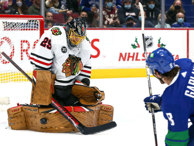 VANCOUVER, BC - NOVEMBER 21: Chicago Blackhawks Goalie Marc-Andre Fleury (29) makes a save against Vancouver Canucks Right Wing Conor Garland (8) during their NHL game at Rogers Arena on November 21, 2021 in Vancouver, British Columbia, Canada.