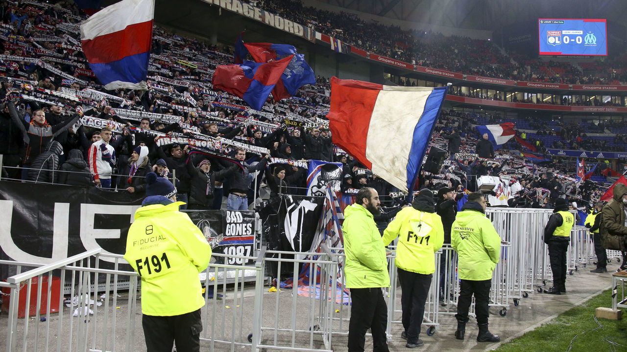 LYON, FRANCE - NOVEMBER 21: Supporters of Lyon still chanting after the match is stopped after only few minutes when Dimitri Payet of OM is hit by a plastic bottle of water thrown by a supporter of Lyon during the Ligue 1 Uber Eats match between Olympique Lyonnais (OL) and Olympique de Marseille (OM) at Groupama Stadium on November 21, 2021 in Decines near Lyon, France. . After two hours of waiting, the match is definitely stopped and supporters have to leave the stadium, frustrated.