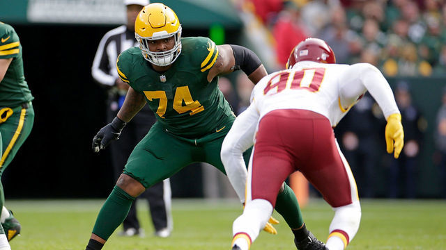 GREEN BAY, WISCONSIN - OCTOBER 24: Elgton Jenkins #74 of the Green Bay Packers pass blocks against the Washington Football Team at Lambeau Field on October 24, 2021 in Green Bay, Wisconsin. Green Bay defeated Washington 24-10.