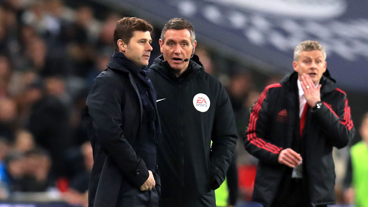 Tottenham Hotspur manager Mauricio Pochettino (left) speaks to fourth official Andre Marriner as Manchester United's interim manager Ole Gunnar Solskjaer (right) looks on during the Premier League match at Wembley Stadium, London.